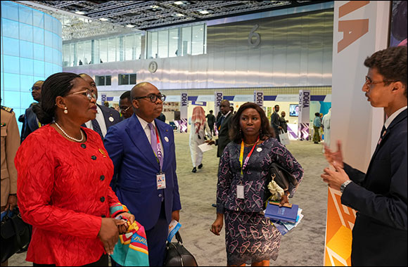 Togolese Prime Minister Victoire Sidemeho Tomegah-Dogbe (in red) visiting Education Above All's information booth at the UN's fifth Least Developed Countries conference in Doha